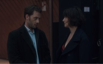 Movie still from “Let the Sunshine In” (2017), directed by Claire Denis – A man and a woman standing next to each other; Medium shot, Over the shoulder angle