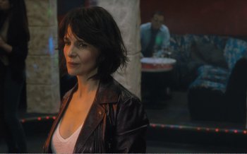 Movie still from “Let the Sunshine In” (2017), directed by Claire Denis – A woman in a leather jacket standing in front of a mirror; Close Up shot, Over the shoulder angle