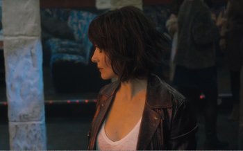Movie still from “Let the Sunshine In” (2017), directed by Claire Denis – A person wearing a leather jacket; Close Up shot, Over the shoulder angle