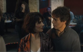 Movie still from “Let the Sunshine In” (2017), directed by Claire Denis – A man and a woman standing next to each other; Close Up shot, Over the shoulder angle