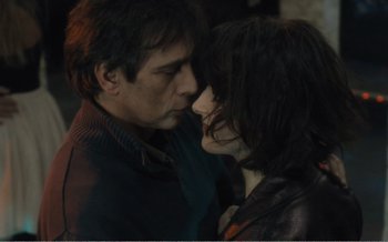 Movie still from “Let the Sunshine In” (2017), directed by Claire Denis – A man and a woman are kissing in a dark room; Close Up shot, High angle