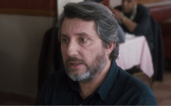 Movie still from “Let the Sunshine In” (2017), directed by Claire Denis – A person with a beard; Close Up shot, Over the shoulder angle
