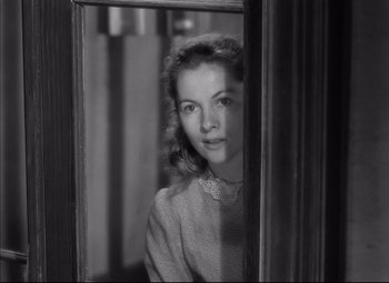 Movie still from “Letter from an Unknown Woman” (1948), directed by Max Ophüls – A young woman standing in front of a mirror looking at the camera; Close Up shot, Over the shoulder angle