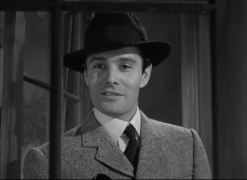 Movie still from “Letter from an Unknown Woman” (1948), directed by Max Ophüls – A black and white photo of a man wearing a suit and a hat; Close Up shot, Low angle