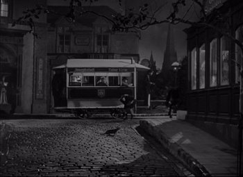 Movie still from “Letter from an Unknown Woman” (1948), directed by Max Ophüls – A black and white photo of a trolley car on a street; Extreme Wide shot, High angle