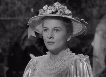 Movie still from “Letter from an Unknown Woman” (1948), directed by Max Ophüls – A woman wearing a hat with flowers on top of her head; Close Up shot, Low angle