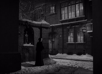 Movie still from “Letter from an Unknown Woman” (1948), directed by Max Ophüls – A person standing in the middle of a snowy street; Extreme Wide shot, Low angle
