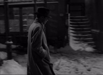 Movie still from “Letter from an Unknown Woman” (1948), directed by Max Ophüls – A black and white photo of a man walking in the snow; Wide shot, High angle