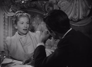 Movie still from “Letter from an Unknown Woman” (1948), directed by Max Ophüls – A man and a woman sitting at a dinner table; Medium shot, Over the shoulder angle