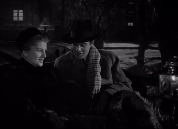 Movie still from “Letter from an Unknown Woman” (1948), directed by Max Ophüls – A man and a woman sitting next to each other on a bench; Medium shot, High angle