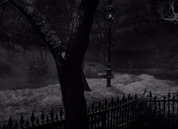 Movie still from “Letter from an Unknown Woman” (1948), directed by Max Ophüls – A black and white photo of a street light and a tree; Extreme Wide shot, High angle