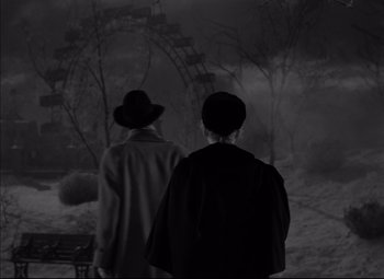 Movie still from “Letter from an Unknown Woman” (1948), directed by Max Ophüls – Two men in hats are walking in the dark; Wide shot, High angle