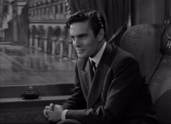 Movie still from “Letter from an Unknown Woman” (1948), directed by Max Ophüls – Black and white photograph of a man in a suit and tie; Medium shot, High angle