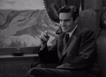 Movie still from “Letter from an Unknown Woman” (1948), directed by Max Ophüls – A black and white photo of a man smoking a cigarette; Medium shot, High angle