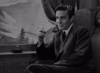 Movie still from “Letter from an Unknown Woman” (1948), directed by Max Ophüls – A black and white photo of a man smoking a cigarette; Medium shot, Low angle