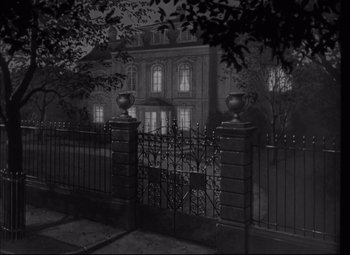 Movie still from “Letter from an Unknown Woman” (1948), directed by Max Ophüls – A black - and - white photo of a house at night; Extreme Wide shot, High angle