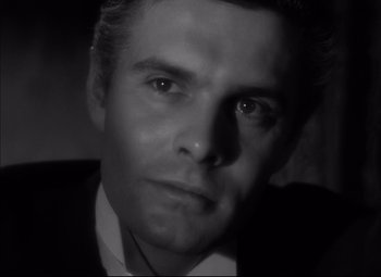 Movie still from “Letter from an Unknown Woman” (1948), directed by Max Ophüls – Black and white photograph of a man in a suit and tie; Close Up shot, High angle