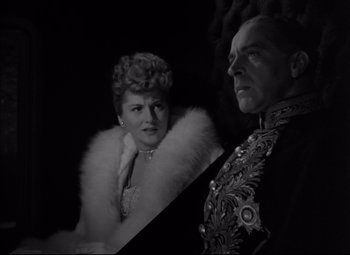 Movie still from “Letter from an Unknown Woman” (1948), directed by Max Ophüls – An old photo of a man and a woman; Medium shot, Low angle