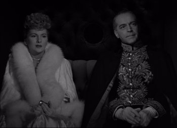 Movie still from “Letter from an Unknown Woman” (1948), directed by Max Ophüls – An old photo of a man and a woman sitting in a car; Medium shot, High angle