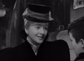 Movie still from “Letter from an Unknown Woman” (1948), directed by Max Ophüls – A woman wearing a hat and a black coat; Close Up shot, Over the shoulder angle