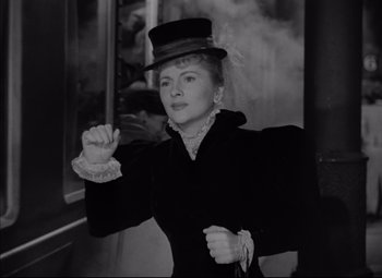 Movie still from “Letter from an Unknown Woman” (1948), directed by Max Ophüls – An old photo of a woman wearing a top hat; Medium shot, Over the shoulder angle