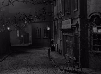 Movie still from “Letter from an Unknown Woman” (1948), directed by Max Ophüls – A bicycle parked on the side of the street; Extreme Wide shot, High angle