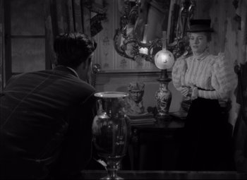 Movie still from “Letter from an Unknown Woman” (1948), directed by Max Ophüls – Two people are standing in front of a mirror; Medium shot, Over the shoulder angle