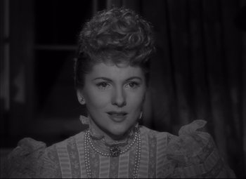 Movie still from “Letter from an Unknown Woman” (1948), directed by Max Ophüls – An old photo of a woman in a victorian dress; Close Up shot, Over the shoulder angle