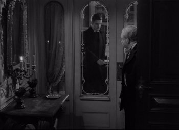 Movie still from “Letter from an Unknown Woman” (1948), directed by Max Ophüls – A man in a suit and tie standing in front of another man; Medium shot, Over the shoulder angle