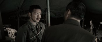 Movie still from “Letters from Iwo Jima” (2006), directed by Clint Eastwood – A man in a uniform talking to another man in a suit and tie; Close Up shot, Over the shoulder angle