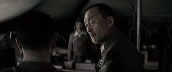 Movie still from “Letters from Iwo Jima” (2006), directed by Clint Eastwood – A man in a military uniform looking into the camera; Close Up shot, Over the shoulder angle