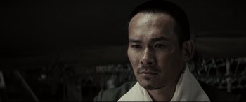 Movie still from “Letters from Iwo Jima” (2006), directed by Clint Eastwood – A person wearing a white shirt; Close Up shot, Low angle