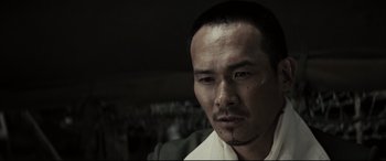 Movie still from “Letters from Iwo Jima” (2006), directed by Clint Eastwood – A person wearing a white shirt; Close Up shot, Low angle