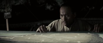 Movie still from “Letters from Iwo Jima” (2006), directed by Clint Eastwood – A man leaning on a table looking at the camera; Close Up shot, High angle