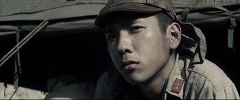 Movie still from “Letters from Iwo Jima” (2006), directed by Clint Eastwood – A man wearing a hat looking at the camera; Close Up shot, Low angle