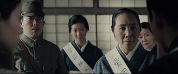 Movie still from “Letters from Iwo Jima” (2006), directed by Clint Eastwood – A group of people standing next to each other in a room; Medium shot, Low angle