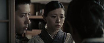 Movie still from “Letters from Iwo Jima” (2006), directed by Clint Eastwood – A young asian woman wearing a kimono looking at the camera; Close Up shot, Over the shoulder angle