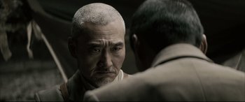 Movie still from “Letters from Iwo Jima” (2006), directed by Clint Eastwood – An older man looking at himself in the mirror; Close Up shot, Over the shoulder angle