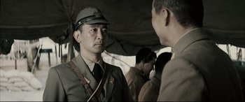 Movie still from “Letters from Iwo Jima” (2006), directed by Clint Eastwood – A man in a military uniform talking to another man; Close Up shot, Over the shoulder angle