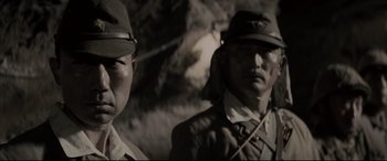 Movie still from “Letters from Iwo Jima” (2006), directed by Clint Eastwood – A couple of men standing next to each other; Close Up shot, Low angle