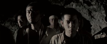 Movie still from “Letters from Iwo Jima” (2006), directed by Clint Eastwood – A group of men standing next to each other in the dark; Close Up shot, Low angle