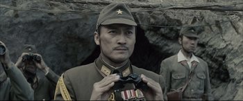 Movie still from “Letters from Iwo Jima” (2006), directed by Clint Eastwood – A man in a military uniform holding a pair of binoculars; Close Up shot, Low angle