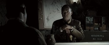 Movie still from “Letters from Iwo Jima” (2006), directed by Clint Eastwood – A man sitting in front of a mirror in a room; Close Up shot, Over the shoulder angle