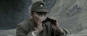 Movie still from “Letters from Iwo Jima” (2006), directed by Clint Eastwood – A man wearing a hat and holding a pair of binoculars; Close Up shot, Low angle