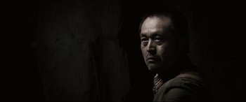 Movie still from “Letters from Iwo Jima” (2006), directed by Clint Eastwood – A person in a dark room; Close Up shot, Low angle