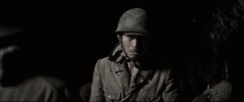 Movie still from “Letters from Iwo Jima” (2006), directed by Clint Eastwood – A man wearing a military uniform and a helmet; Close Up shot, Low angle