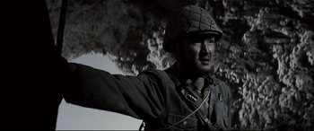 Movie still from “Letters from Iwo Jima” (2006), directed by Clint Eastwood – A man in a military uniform and a helmet; Close Up shot, Low angle