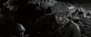 Movie still from “Letters from Iwo Jima” (2006), directed by Clint Eastwood – A man wearing a hat and a uniform; Close Up shot, High angle