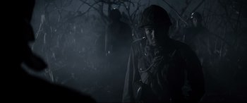 Movie still from “Letters from Iwo Jima” (2006), directed by Clint Eastwood – A man in a military uniform in a dark forest; Close Up shot, Low angle