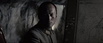 Movie still from “Letters from Iwo Jima” (2006), directed by Clint Eastwood – A man in a military uniform looking at the camera; Close Up shot, Low angle